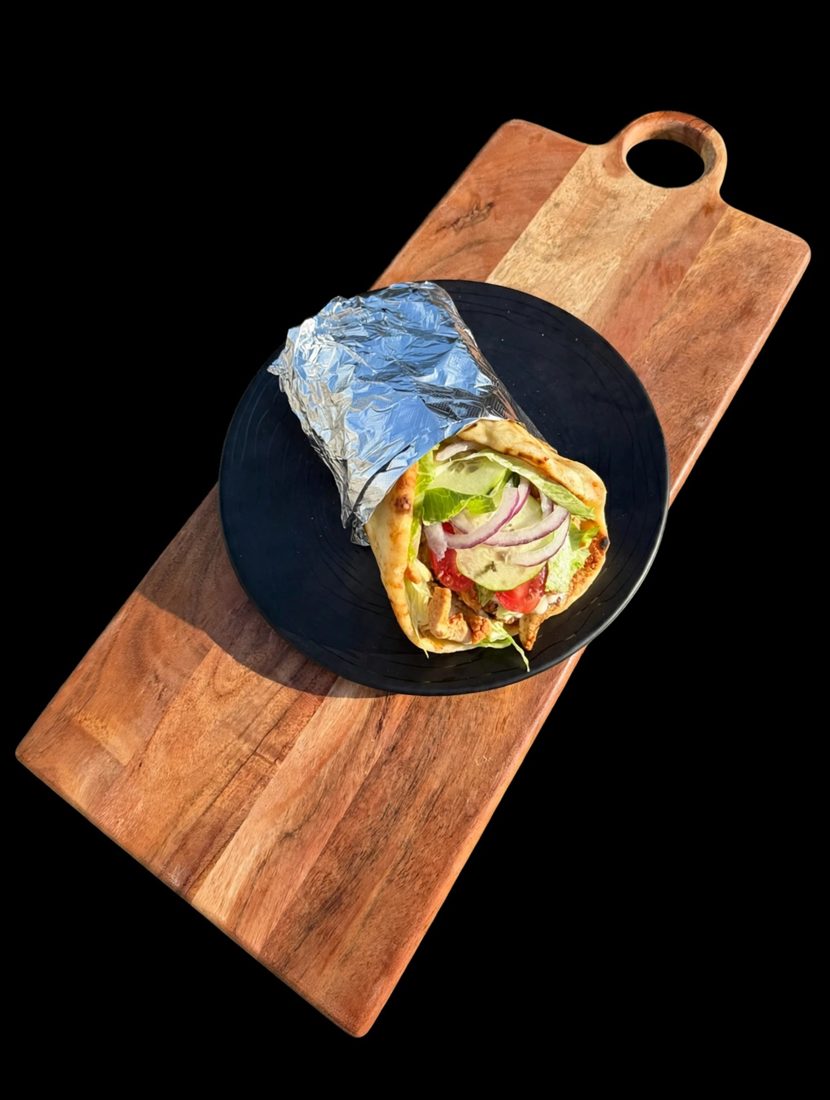 Chicken gyro wrap with lettuce, tomato, cucumber and red onion