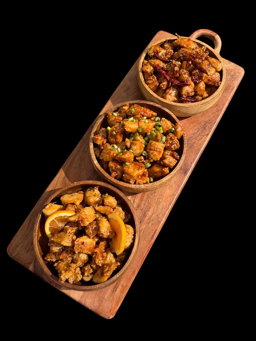 General Tso, teriyaki and orange chicken in wooden bowls